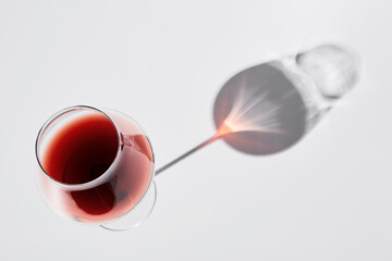 Red wine is in wineglass isolated on white background.
