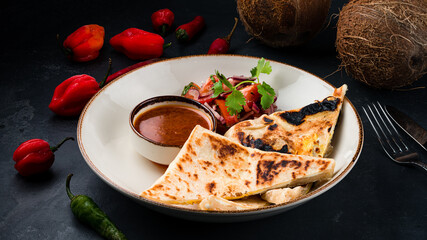Flatbread stuffed with sauce, fresh vegetable salad and chili pepper.