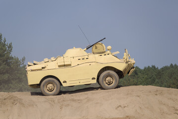 COMBAT RECONNAISSANCE-PATROL VEHICLE - Military vehicle in desert camouflage in the wilderness