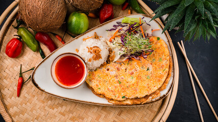 Omelet with tomatoes and onions, rice, sauce and salad of fresh cabbage, carrots, lettuce and microgreens.