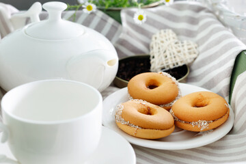 Two cups of hot tea with delicious cookies on  wooden table.