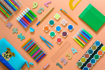 Flat lay with different school supplies on colored background. Copy space. Top view.