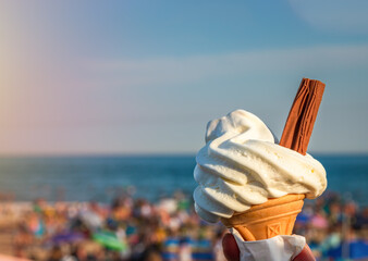 Ice cream cone held up to the hot summer sky in Bournemouth, England