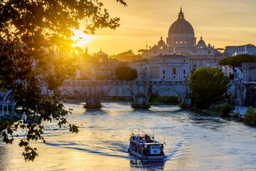 St. Peter's basilica dome and St. Angel bridge over Tiber river at sunset in Rome, Italy - obrazy, fototapety, plakaty
