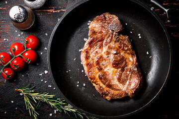 Frying pan with grilled steak. 