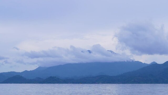 Time lapse moving clouds over mountain sea sunrise sky landscape in Indonesia