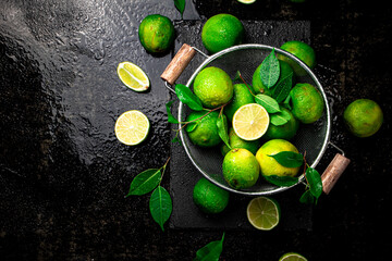 Fragrant lime with leaves in a colander. 