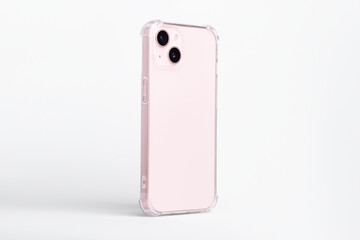 iPhone 13 case mock up side view. Pink smart phone in clear transparent soft silicone case isolated...