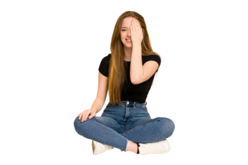 Young redhead woman sitting on the floor cut out isolated suffering neck pain due to sedentary lifestyle.