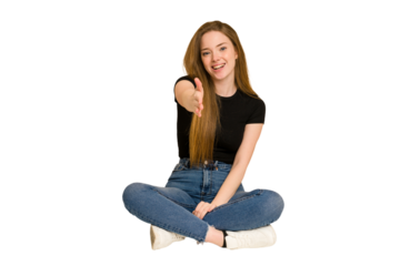 Young redhead woman sitting on the floor cut out isolated shocked covering mouth with hands.