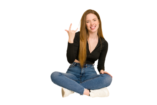 Young redhead woman sitting on the floor cut out isolated showing thumbs up and thumbs down, difficult choose concept