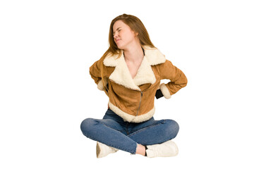 Young redhead woman sitting on the floor cut out isolated taking an oath, putting hand on chest.