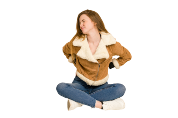 Young redhead woman sitting on the floor cut out isolated taking an oath, putting hand on chest.
