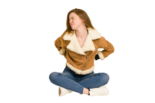 Young redhead woman sitting on the floor cut out isolated taking an oath, putting hand on chest.