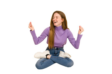 Obraz premium Young redhead woman sitting isolated cut out