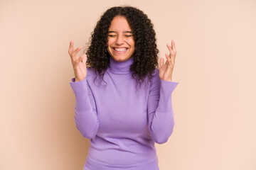 Young african american curly woman isolated joyful laughing a lot. Happiness concept.