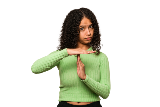 Young african american curly woman isolated showing a timeout gesture.