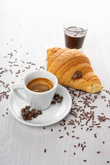 breakfast with coffee and chocolate croissant brioches on a light background
