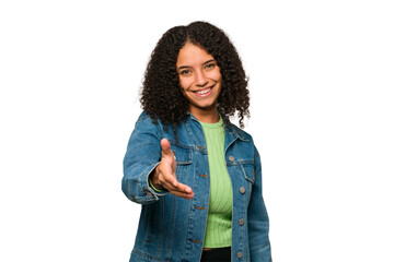 Young african american curly woman isolated stretching hand at camera in greeting gesture. © Asier