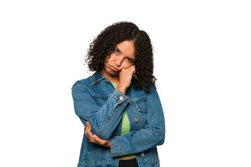 Young african american curly woman isolated tired of a repetitive task.