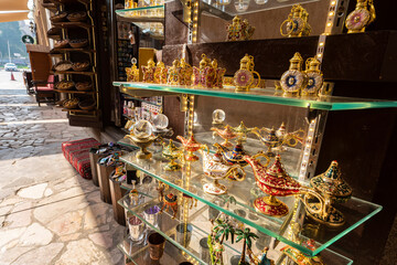 Various colorful expensive souvenirs on the counter in the store at the bazaar in the old city of Dubai. United Arab Emirates.