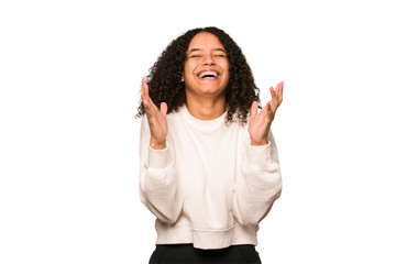 Young african american curly woman isolated laughs out loudly keeping hand on chest.