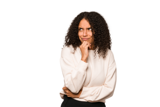 Young african american curly woman isolated looking sideways with doubtful and skeptical expression.