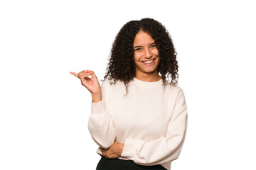 Young african american curly woman isolated smiling cheerfully pointing with forefinger away.