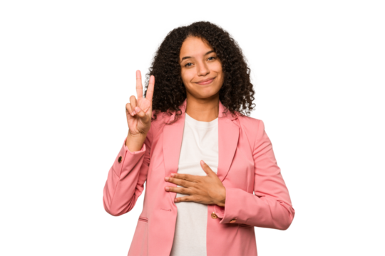 Young african american curly woman isolated taking an oath, putting hand on chest.
