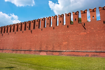The famous Kremlin wall with dovetail crenellations. The texture of the red ancient brick Kremlin...