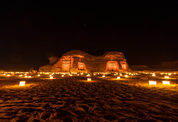Tombs at the Mada'in Saleh (Hegra) archeological site lit up after dark, north west Saudi Arabia