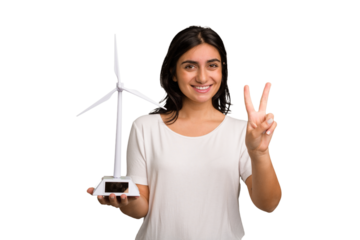Young Indian woman holding a small wind energy mill isolated showing number two with fingers.