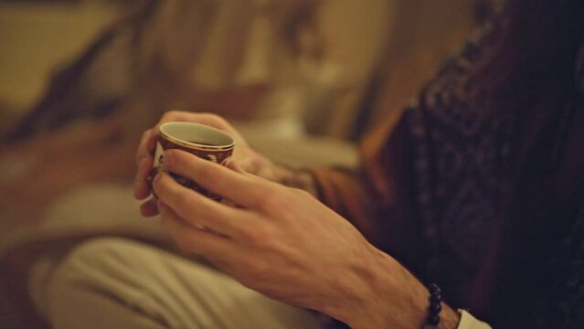 a man hands over a cup of elixir a ayahuasca ritual