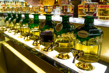 Closeup of bottles of essential oils used in perfume making displayed in a row in market Souk...