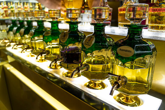 Closeup of bottles of essential oils used in perfume making displayed in a row in market Souk Madinat Jumeirah. Dubai, UAE