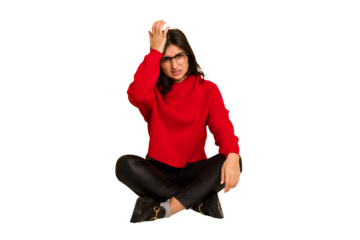 Young indian woman sitting on the floor cut out isolated forgetting something, slapping forehead with palm and closing eyes.