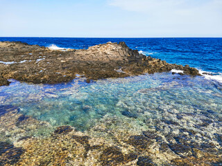 Atlantic Ocean with a natural pool in Caleta de Fuste, Fuerteventura, Spain
