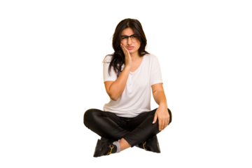 Young indian woman sitting on the floor cut out isolated having a strong teeth pain, molar ache.