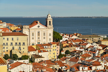 Beautiful colorful and vibrant  cityscape of Lisbon, Portugal.
Church of Sao Vicente of Fora (Igreja de Sao Vicente de Fora) and old buildings in Alfama and Graca districts in Lisbon, Portugal.