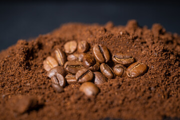 Coffee beans among ground coffee.