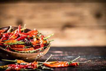 Dried chili peppers in a plate on the table. 