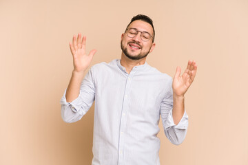 Adult latin man cut out isolated laughs out loudly keeping hand on chest.