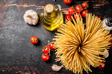 Not cooked spaghetti dry. Against a dark background.