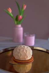 air cake on a copper tray. in the background flowers