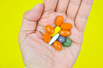 Variety mix Vitamins and minerals supplements tablets pills in hand daily supplements, healthy lifestyle routine, nutrition, alternative medicine.Holistic health. Self care.