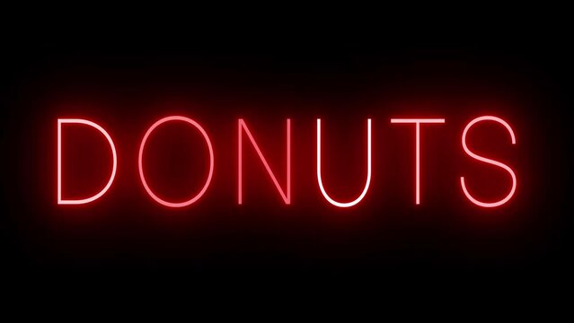 Retro red neon sign against a black wall with DONUT