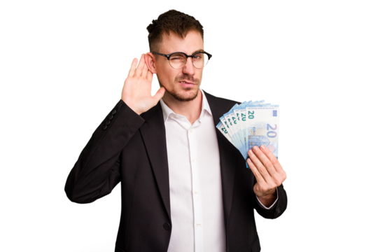 Young business caucasian man holding euro banknotes isolated cut out trying to listening a gossip.
