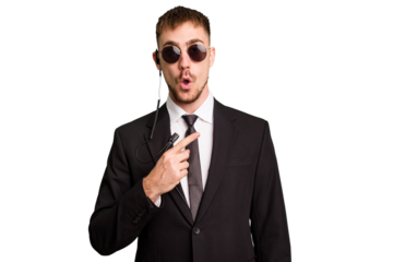 Security bodyguard man wearing a suit isolated cut out pointing to the side