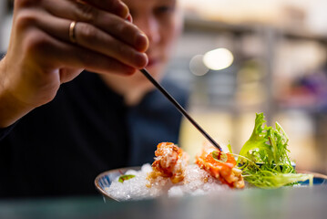 chef decorated plate with food on kitchen