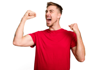 Young caucasian man cut out isolated raising fist after a victory, winner concept.